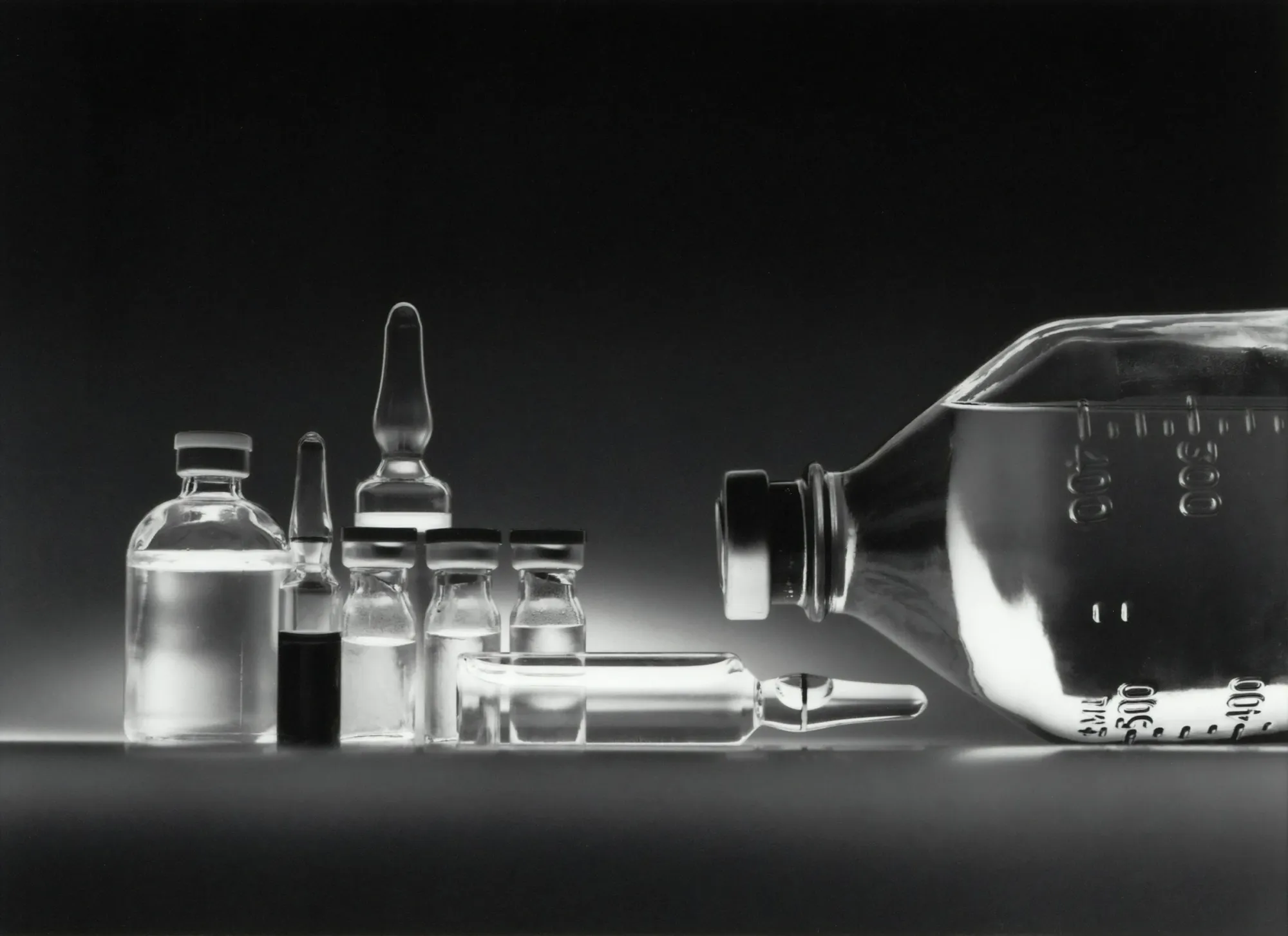Variety of chemotherapy drugs in vials and an IV bottle.