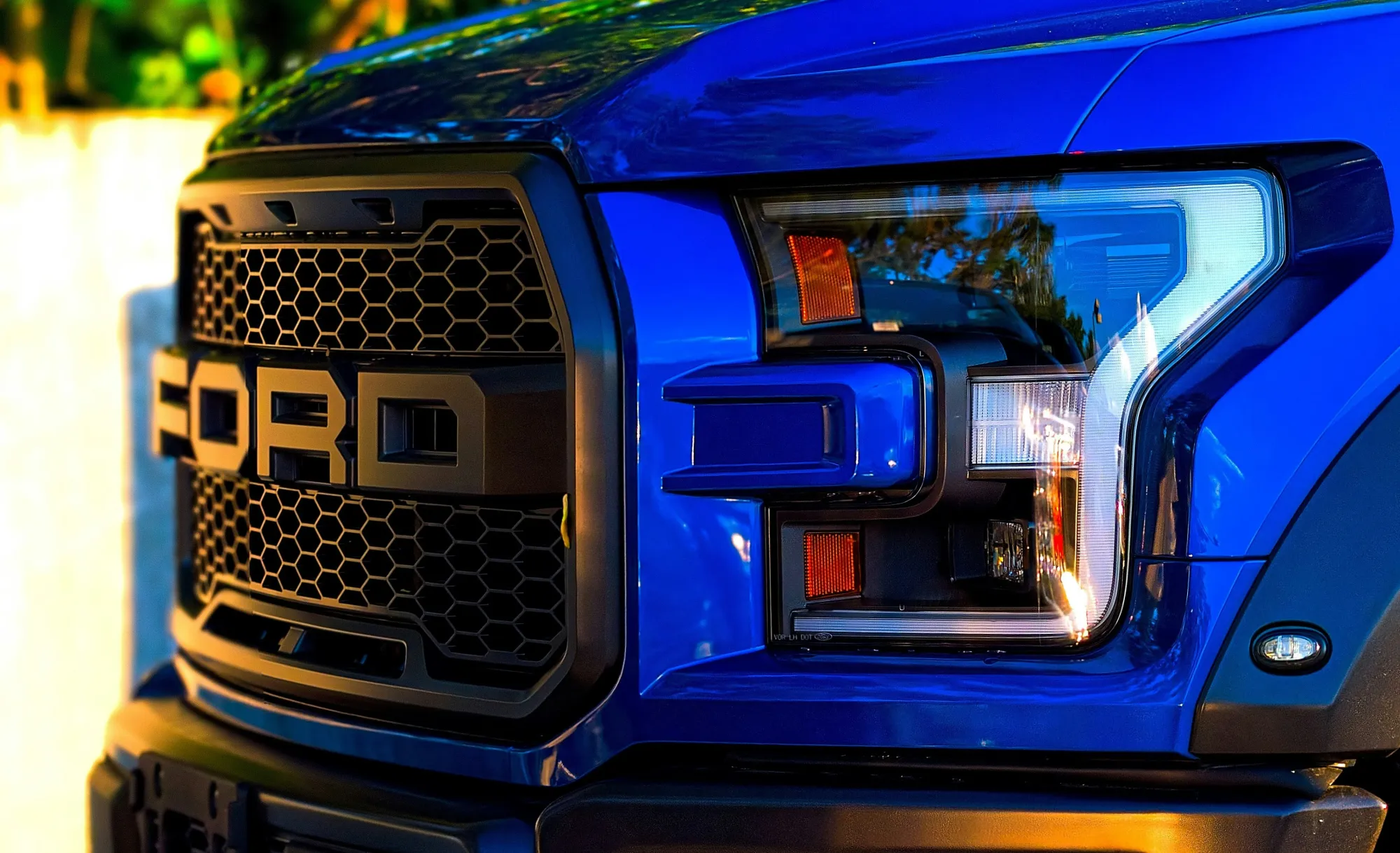 A Blue Ford F-150 Raptor Luxury Truck at Sunset.