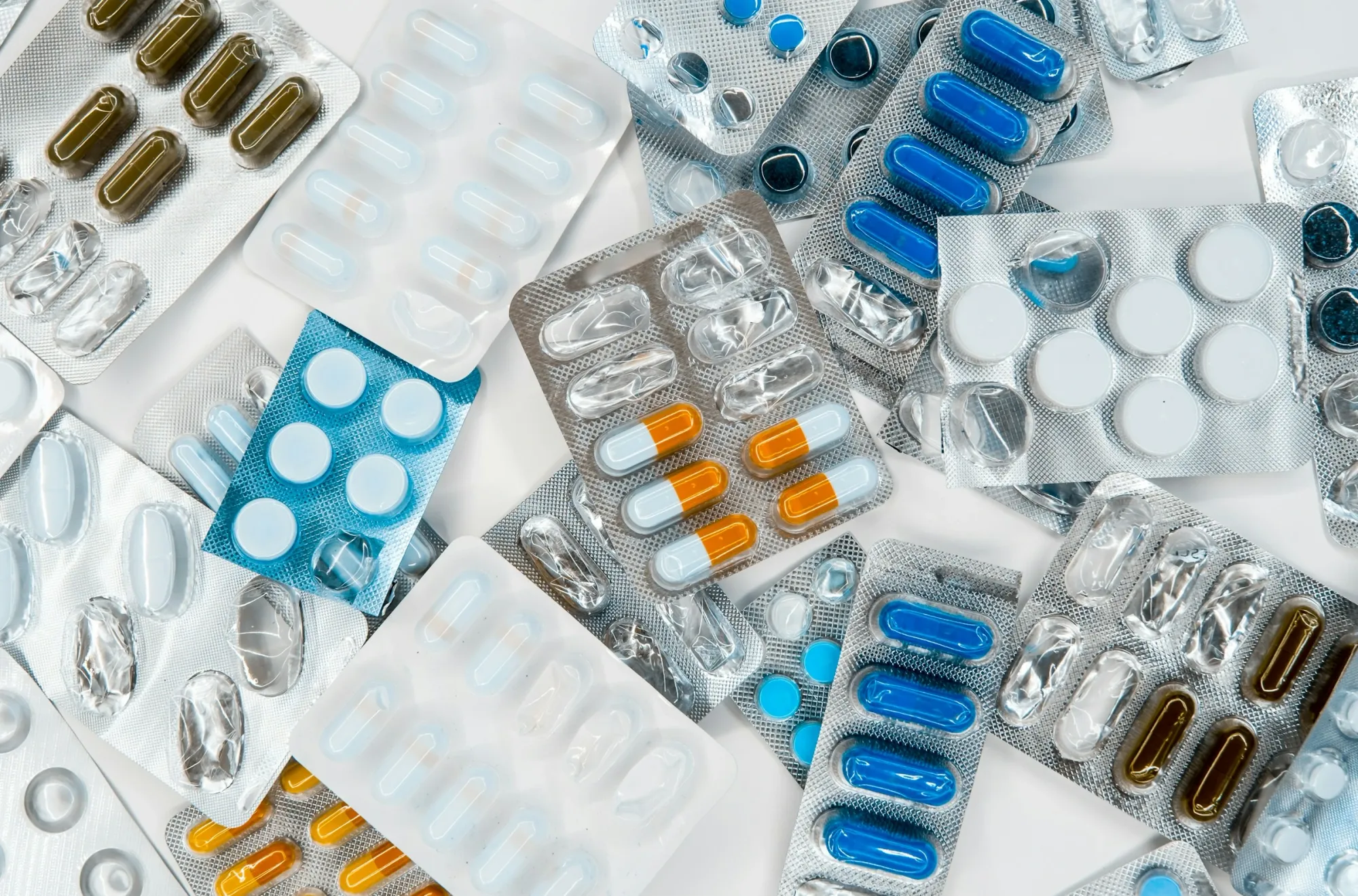 Pharmaceuticals in packages of different colors, antibiotics medicine tablets, colorful antibacterial tablets lie...