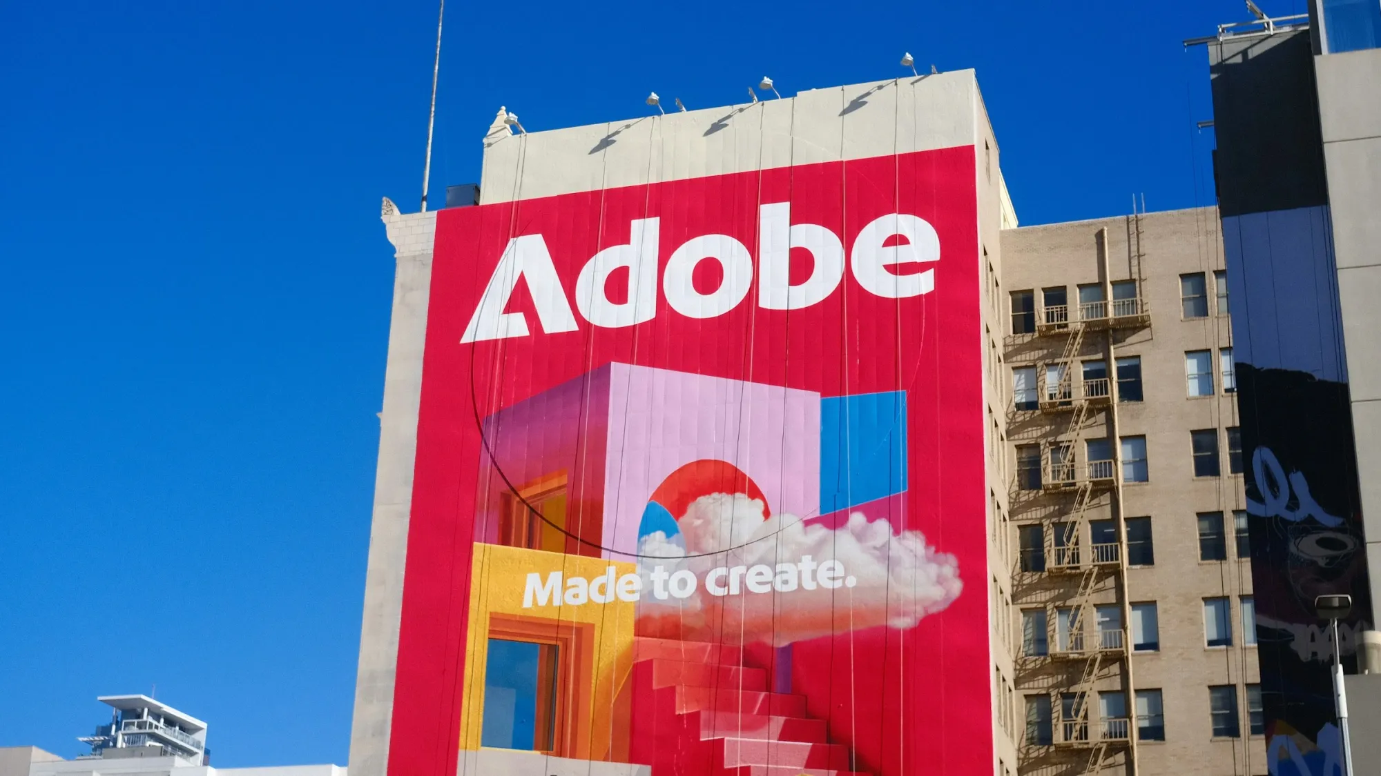 Adobe Q3: Small Beat, Raised Outlook, and the 1 Billion User Milestone